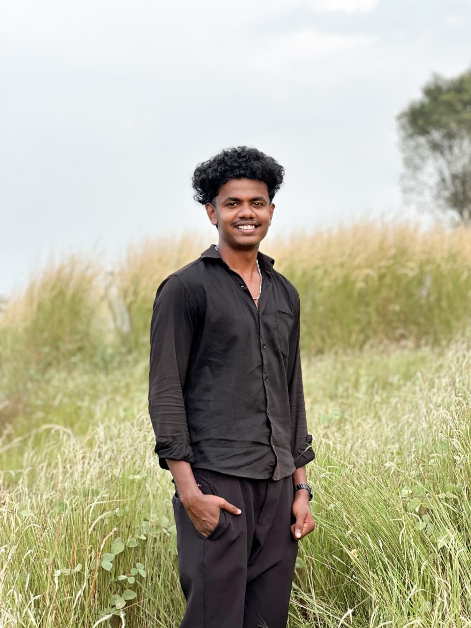 A digital marketing expert standing outdoors in a field.